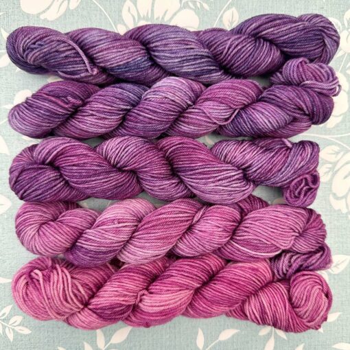 Petal Fade gradient yarn pack transitioning from rosy pink to vibrant violet.